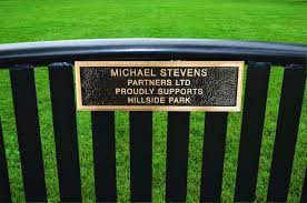 slatted metal bench bronze plaques
