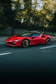 red ferrari on the road free stock photo