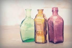 coloured glass bottles on a rustic