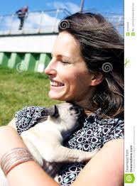 Smiling woman hugging pug puppy - smiling-woman-hugging-pug-puppy-22440342