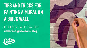 painting a mural on a brick wall