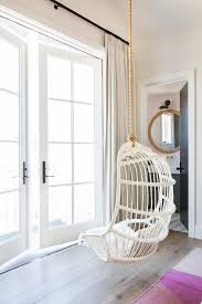 Pink stripe curtains accent bedroom windows featuring a corner anthropologie woven hanging chair. White Hanging Chair With Pink And Orange Rug Transitional Girl S Room