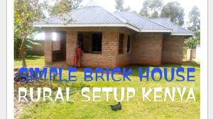 a simple brick house in a rural setup