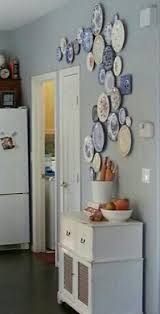 decorate a wall with hanging plates for