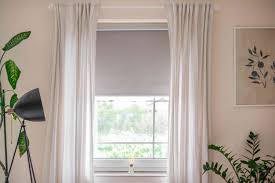 how to hang curtains over blinds