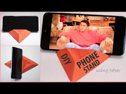 You can create a fun phone holder from a toilet paper roll by placing it upwards and cutting two diagonal slits to form an angle. Video How To Make Mobile Phone Holder