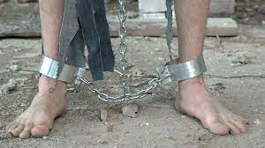 the legs of the prisoner in chains close... | Stock Video | Pond5