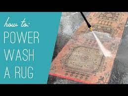 dingy rug with a power washer