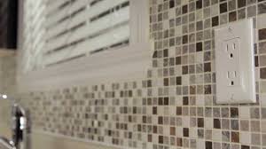 Hold each tile sheet straight across the top and set down your spacers before pressing tile firmly and evenly into the mortar. Rona How To Install Mosaic Tiles Youtube