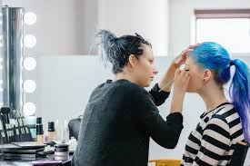 makeup artist applying makeup to model