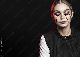 Woman crying with fake blood Stock Photo | Adobe Stock
