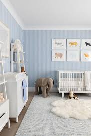 blue nursery with white ladder shelves