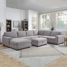 The sectional is covered in a gray colored 100% polyester fabric that is paired with two toss pillows. Langdon Fabric Sectional With Storage Ottoman Costco