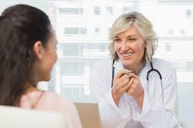 Friendly Female Doctor In Conversation With Patient In The Medical