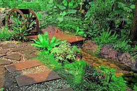 Wooden Water Wheel In The Garden Stock