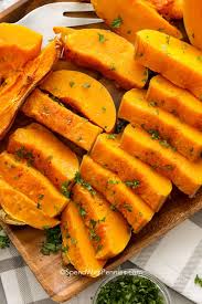 baked ernut squash on a wood plate ready to serve