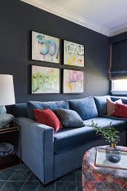 blue velvet sofa on black wall
