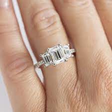Highly reminiscent of old hollywood drama, class and sophistication, emerald cut engagement rings are a popular choice for today's brides. Three Stone Accented Emerald Cut Engagement Ring