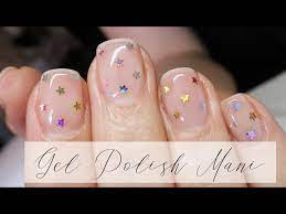 gel polish manicure with glitter stars