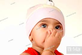 indian baby boy child pressing his nose
