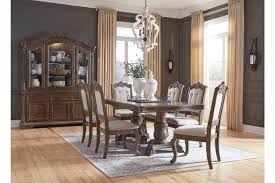 Double pedestal base with stretcher is an inspired choice for a hearty, homey aesthetic. Charmond Extendable Dining Table Ashley Furniture Homestore