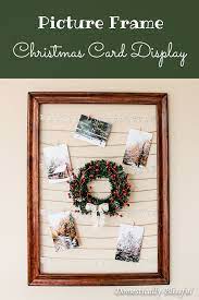 Frame with new year`s decoration, christmas tree branches, golden cones, golden stars and red. Diy Picture Frame Christmas Card Display
