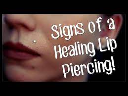 signs of a healing lip piercing you