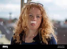 beauty sassy naughty mature redhead woman with curly red blond hair sticks  out her tongue, copy space Stock Photo - Alamy