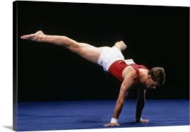 male gymnast peforming a routine in the