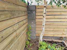 cladding a garden wall with timber