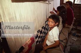 young children weaving carpets for up