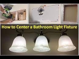 how to center a bathroom light fixture