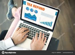 Business Charts And Graphs On Screen With Tax Refund Title
