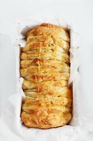 Monkey bread combines several tiny balls of dough coated in butter, cinnamon, and sugar. Easy Cheesy Pull Apart Garlic Bread Made With Biscuit Dough