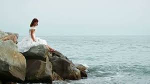 Image result for sitting on rock in sea