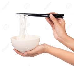 Use your chopsticks to lift the bottom of the noodles to your mouth. Hand Holding Rice Noodles By Chopsticks On A Bowl Isolated On White Background Stock Photo Picture And Royalty Free Image Image 65891309