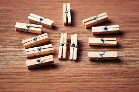 pegs in a square on a wooden plank