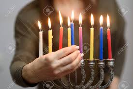 Jewish Woman Lighting Hanukkah Candles In A Menorah People Celebrate