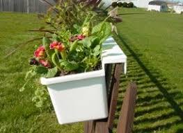This type of fence decor is suitable for growing a wide variety and a large amount of plants because its size and shape can handle more compared to pots. Hanging Planter For Fence Hanging Planters That Hang On Any Type Of Fence Chain Link Fence Planters Fence Hanging Planters Fence Planters Backyard Fences