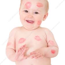 baby covered in kisses stock image