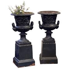 english cast iron urns on plinths from