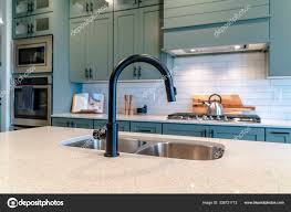 kitchen island sink with black faucet