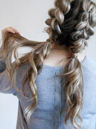 Middle parted hair styled into twin braided buns at back to bring out a child like cute look. 25 Easy And Cute Hairstyles For Curly Hair Southern Living