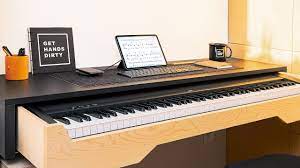 a desk with built in piano keyboard