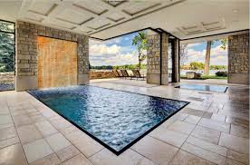 The pool enclosure has an exquisite perimeter with classy cuts and huge pocket openings to allow for ventilation and sun rays when needed. 20 Beautiful Indoor Swimming Pool Designs
