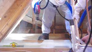 installing spray foam on the attic