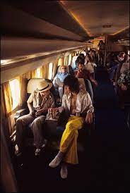 Mick Jagger and friends aboard the Rolling Stones plane, 1972 | Ethan Russell