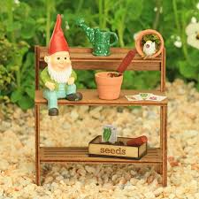 garden potting bench with tiny gnome