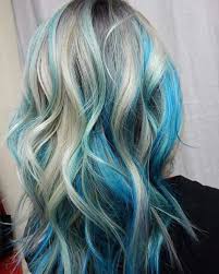 Streaks of rich blue in black hair makes for an interesting combination. I Love The Placement Of These Turquoise And Blue Chunks Hair Styles Blonde And Blue Hair Blue Hair Highlights