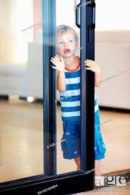 Cute Kid Looking Through Glass Door